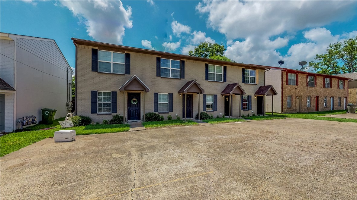 2912 Prairie Flower Circle, Unit D Bryan, TX 77802 - Photo 21 of 22 a front view of a house with a yard and garage