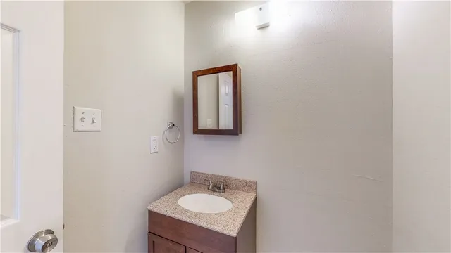 a bathroom with a sink vanity and mirror