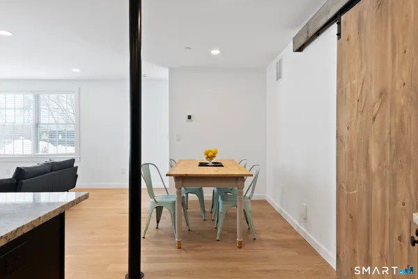 a dining room with furniture and wooden floor