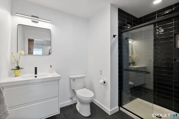 a bathroom with a toilet sink and shower