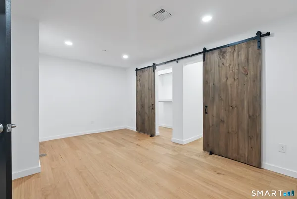 a view of empty room with wooden floor