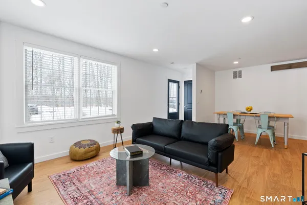 a living room with furniture rug and window