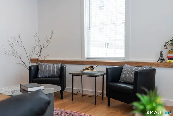 a living room with furniture and a potted plant