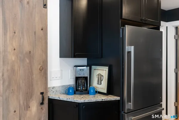 a kitchen with refrigerator and table