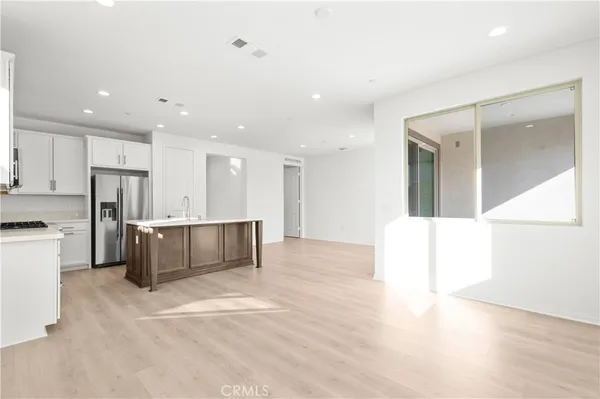 a large kitchen with a refrigerator and a stove top oven