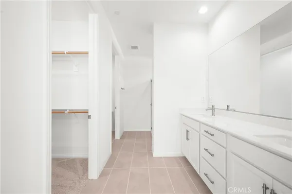 a spacious bathroom with a granite countertop sink and a mirror