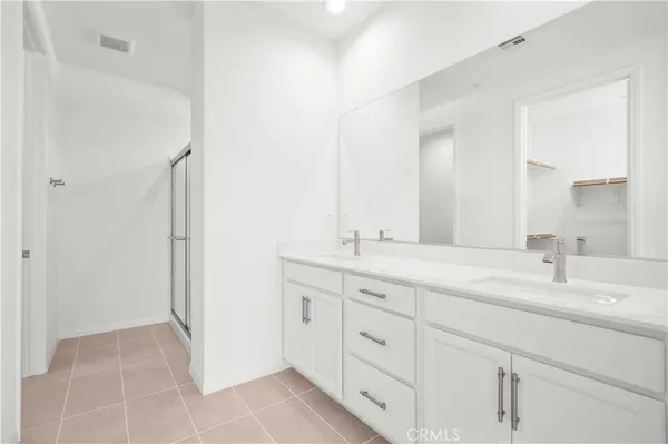 a bathroom with a double vanity sink mirror and