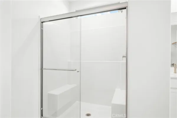 a bathroom with a glass shower door