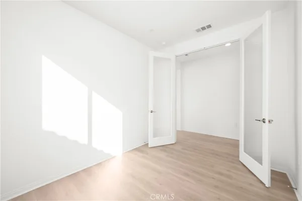 a view of a room with wooden floor