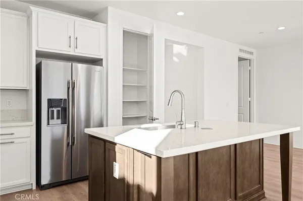 a kitchen with stainless steel appliances a sink and a refrigerator