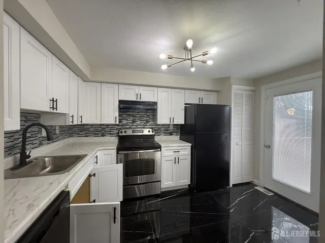 a kitchen with a sink stove and refrigerator