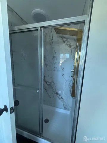 a bathroom with a glass shower door