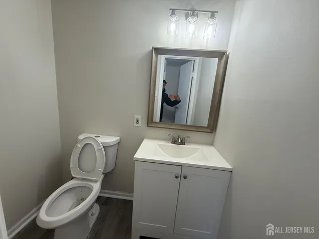 a bathroom with a toilet sink and mirror