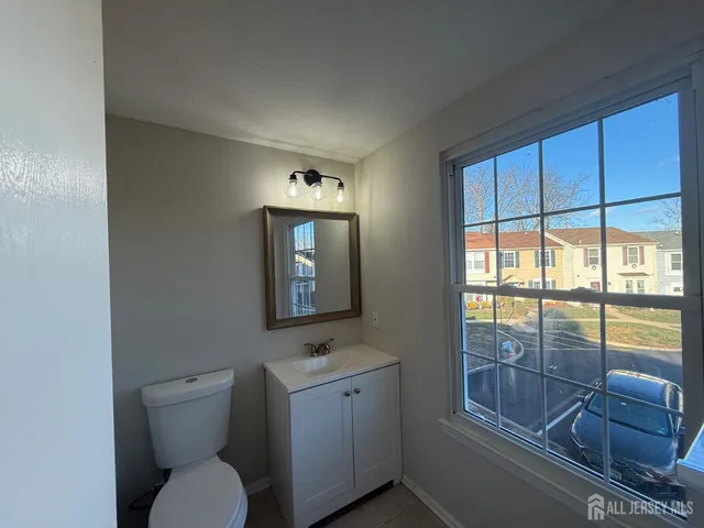 a bathroom with a toilet sink and mirror