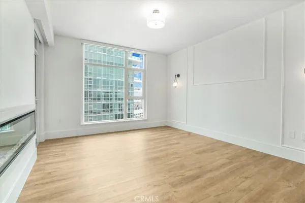 a view of an empty room with wooden floor