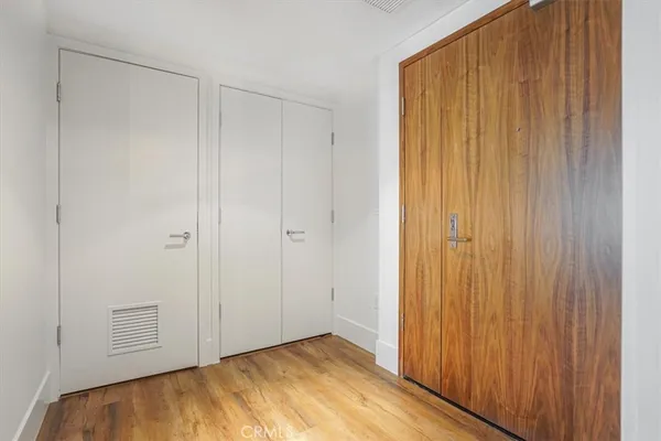a view of a kitchen cabinets and wooden floor