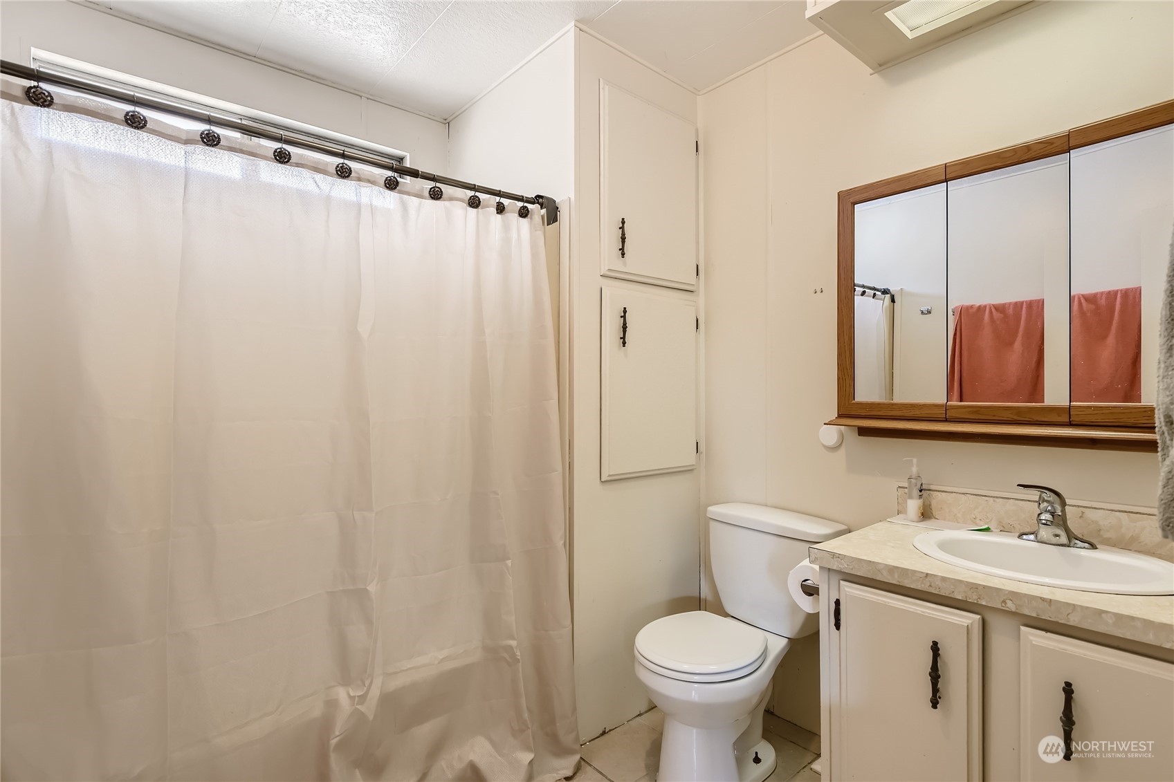 1121 244th Street Southwest, Unit 50 Bothell, WA 98021 - Photo 10 of 22 a bathroom with a sink and a mirror