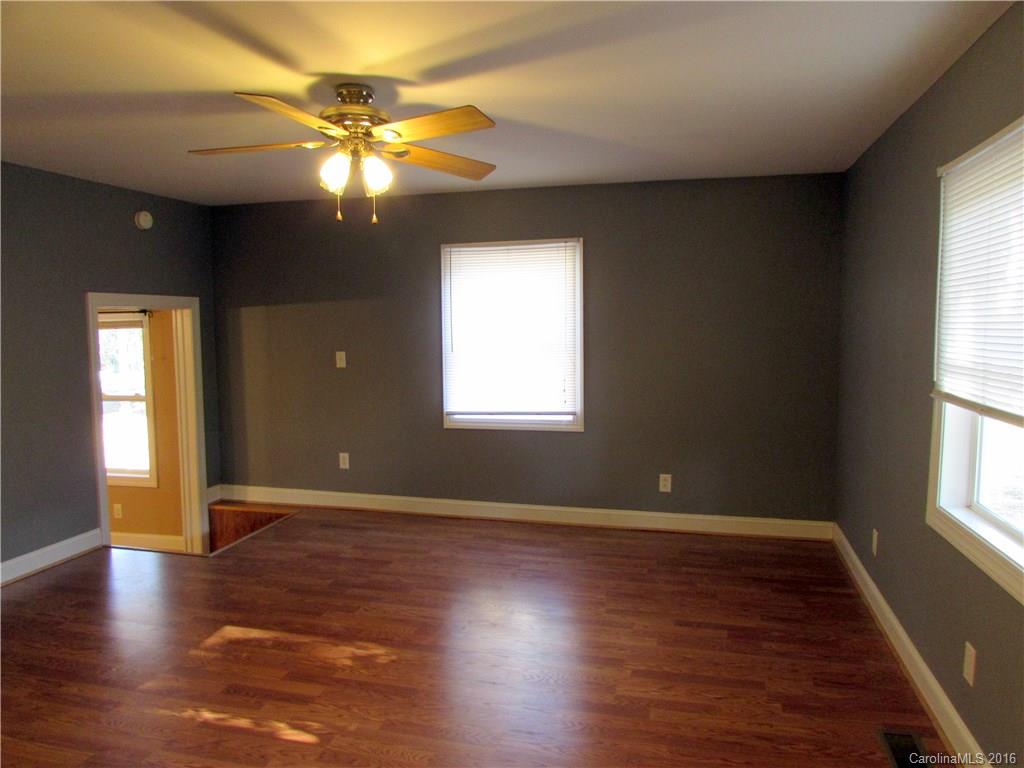 4545 Musket Hill Road Sharon, SC 29742 - Photo 5 of 20 an empty room with wooden floor and windows