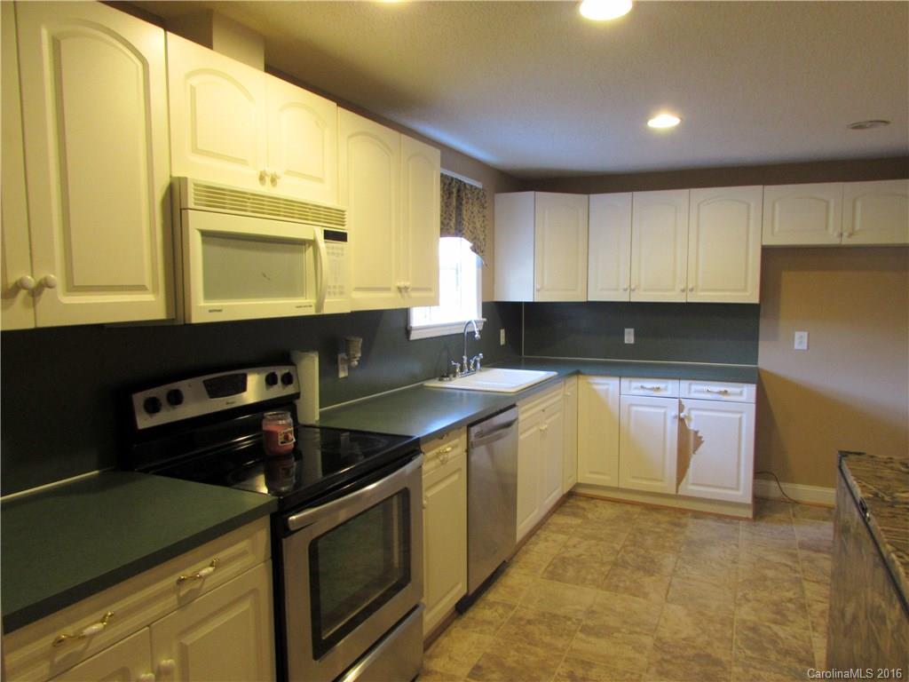 4545 Musket Hill Road Sharon, SC 29742 - Photo 9 of 20 a kitchen with a sink stove and cabinets