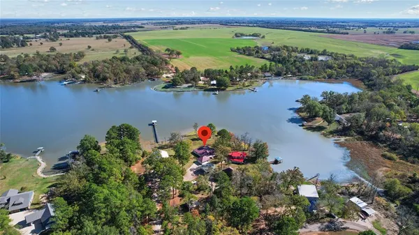 an aerial view of a house and outdoor space