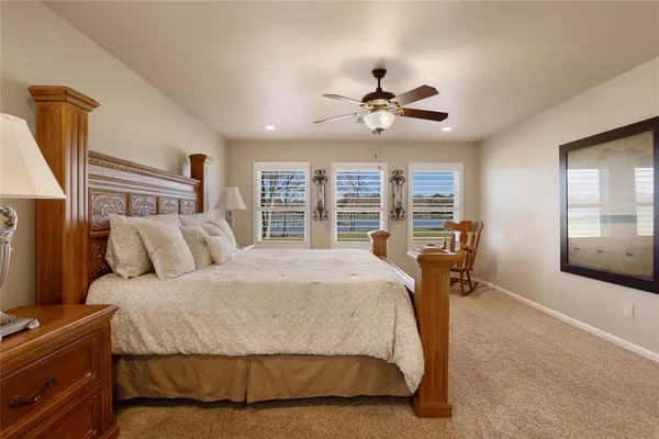 a bedroom with a large bed a flat tv screen and a dresser