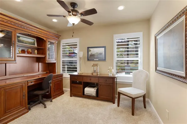 a kitchen with stainless steel appliances granite countertop a stove a sink dishwasher and a dining table with chair