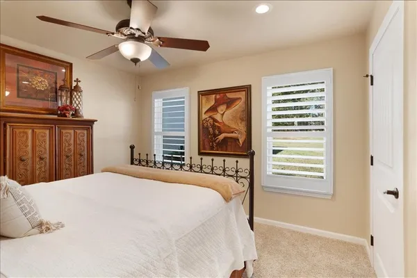 a bedroom with a large bed and a window