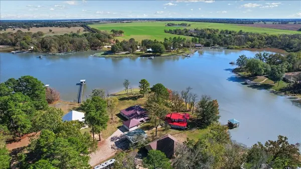 an aerial view of a houses with a lake view
