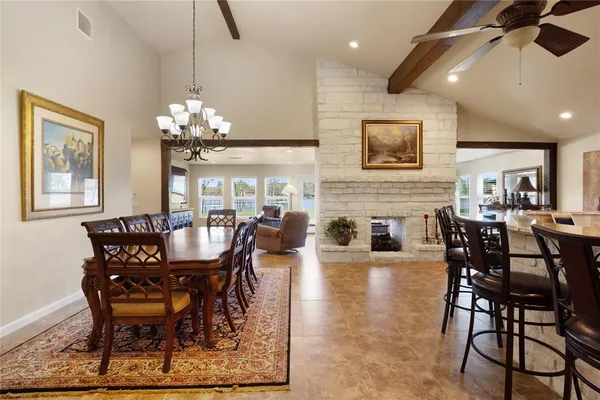 a dining room with furniture a chandelier and wooden floor