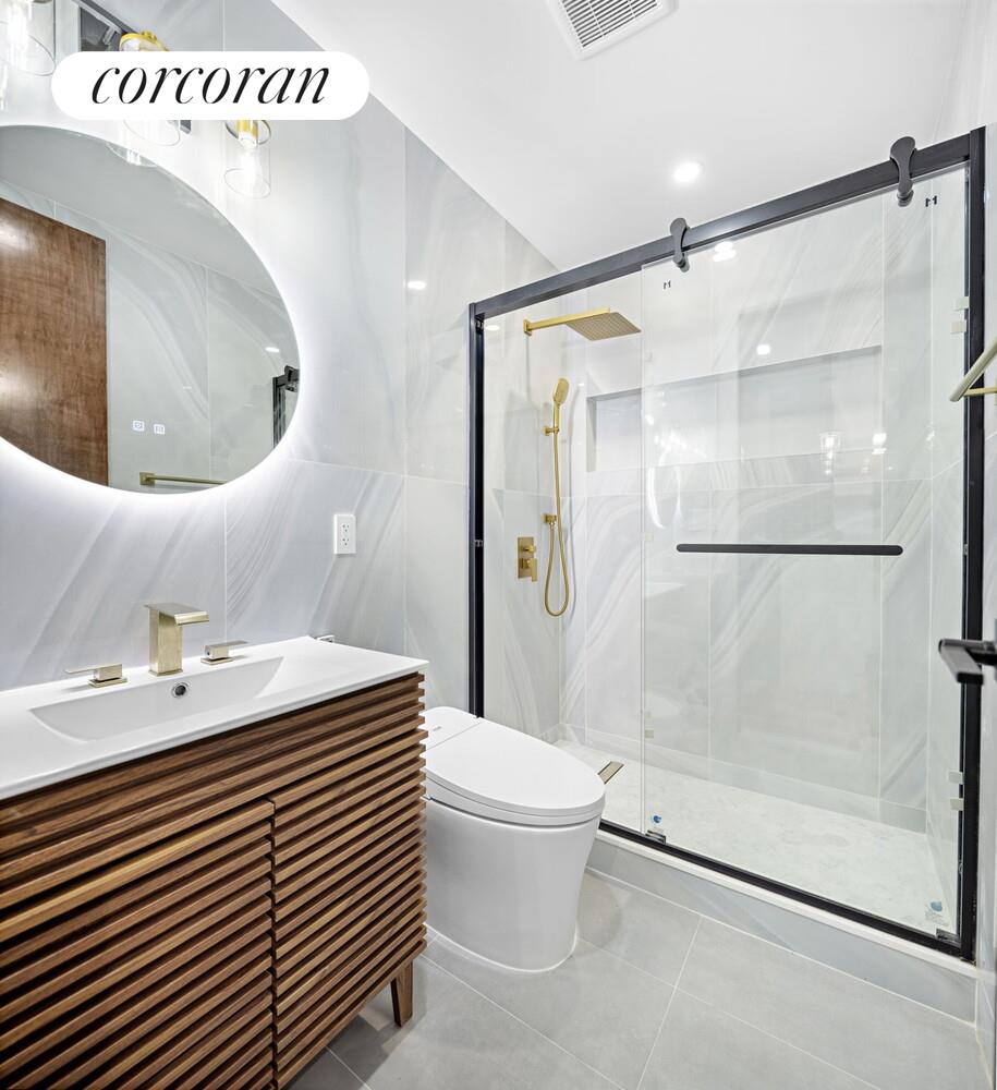 154 9th Avenue Manhattan, NY 10011 - Photo 5 of 11 a bathroom with a sink toilet and shower