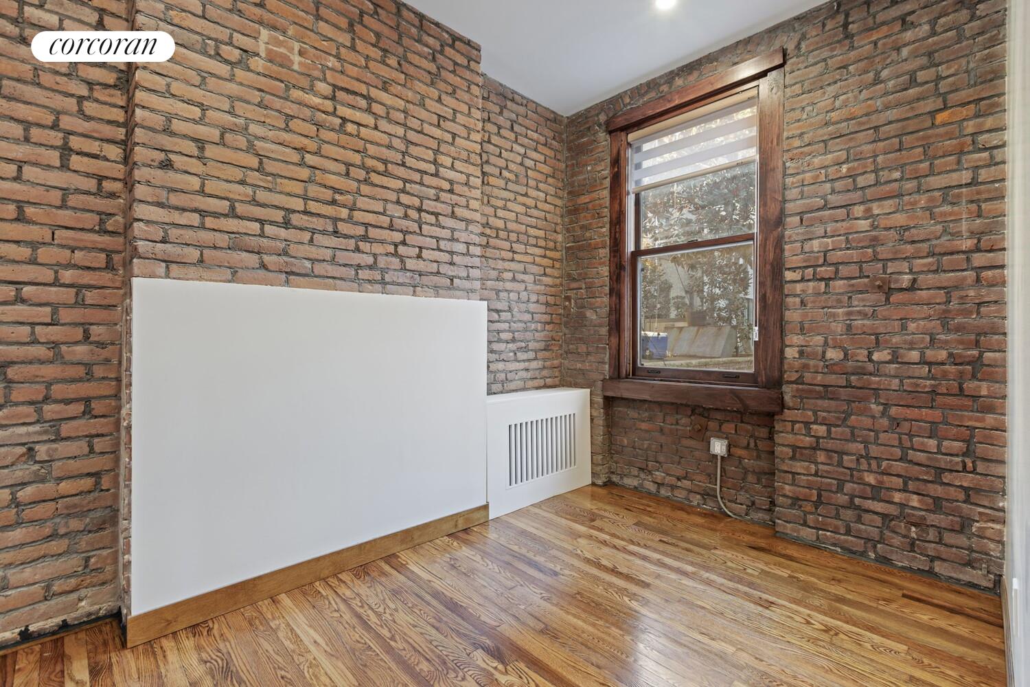 154 9th Avenue Manhattan, NY 10011 - Photo 9 of 11 a view of an empty room with a window
