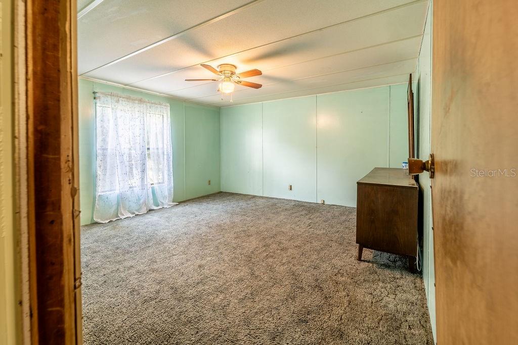 24031 Armadillo Road Astor, FL 32102 - Photo 32 of 43 a view of a hallway with a chandelier