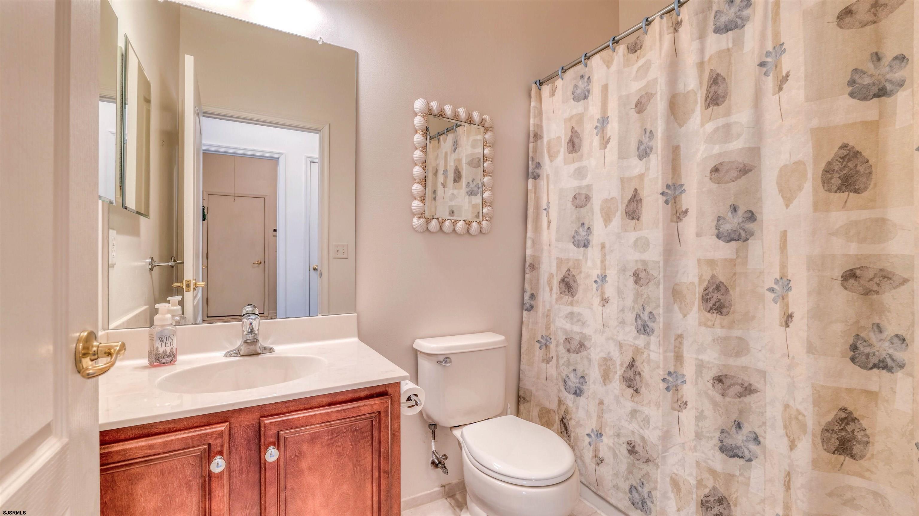 212 Lander Road Egg Harbor Township, NJ 08234 - Photo 20 of 33 a bathroom with a granite countertop sink a toilet and a mirror