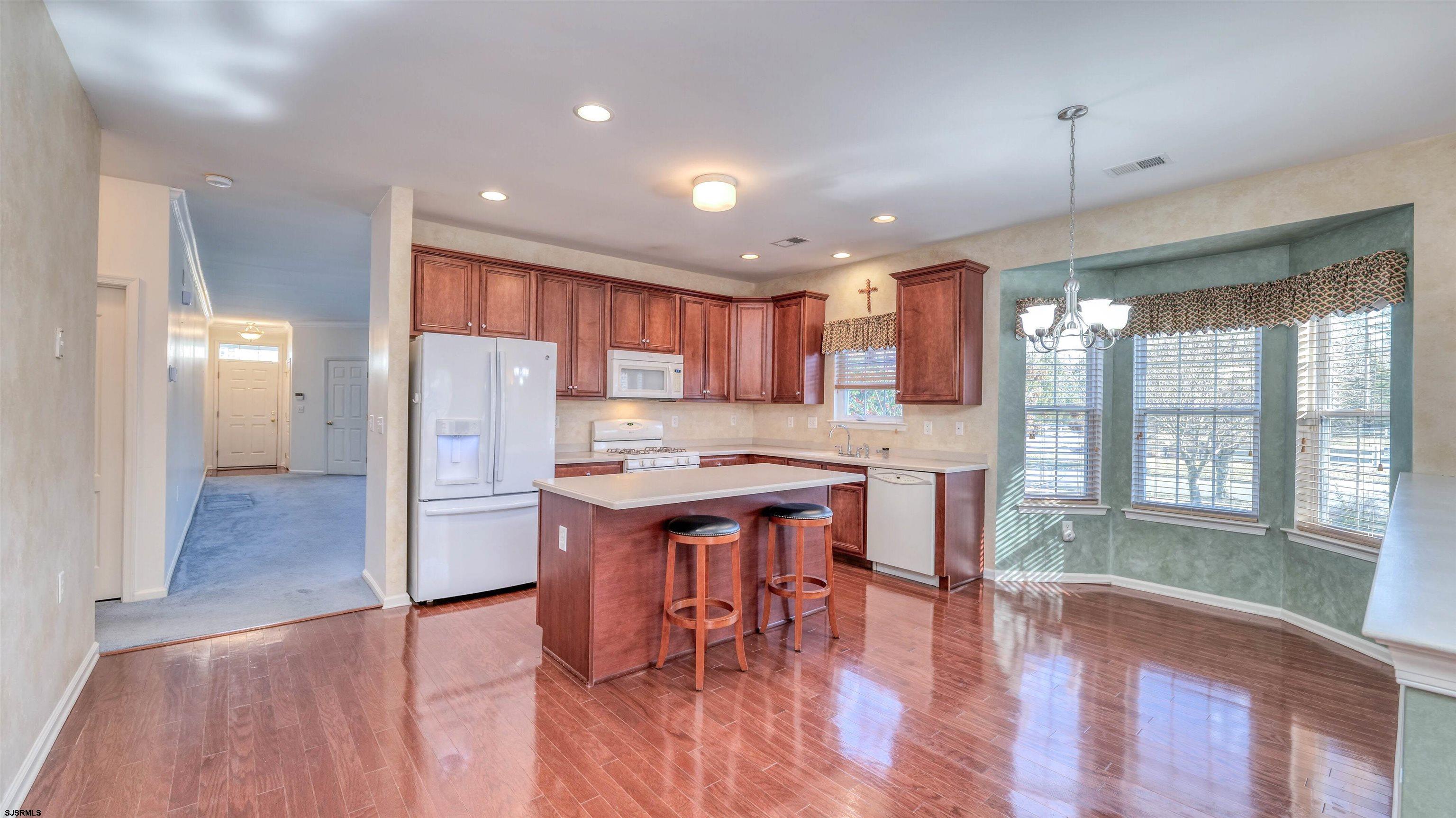 212 Lander Road Egg Harbor Township, NJ 08234 - Photo 10 of 33 a kitchen with stainless steel appliances granite countertop a refrigerator a sink a stove and a wooden floors