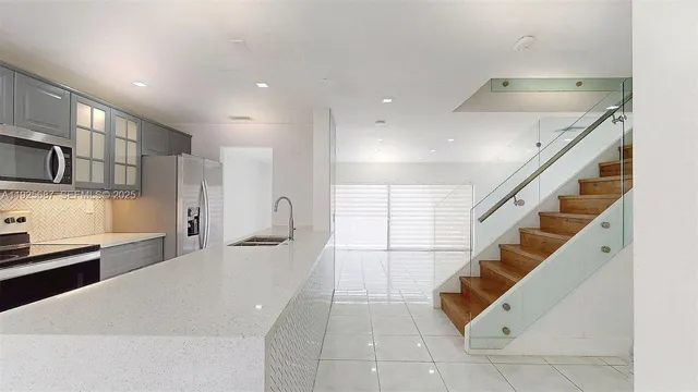 a kitchen with stainless steel appliances a refrigerator and a stove top oven