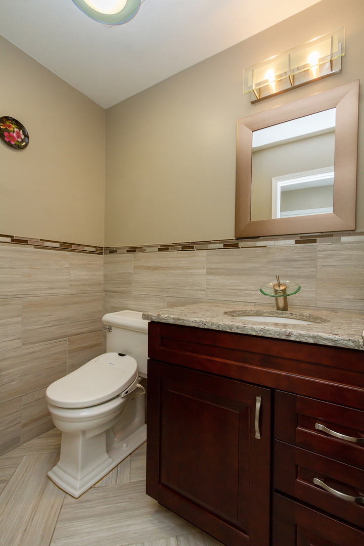 715 Bent Ridge Lane Elgin, IL 60120 - Photo 12 of 20 a bathroom with a granite countertop toilet sink and mirror