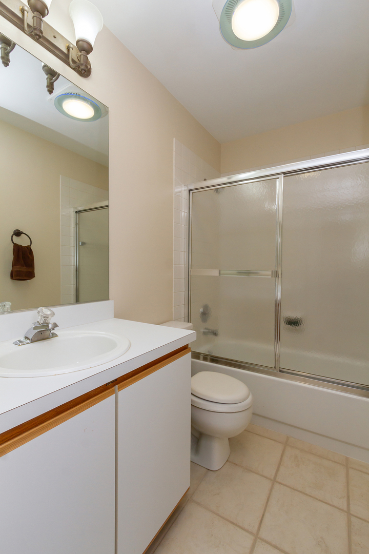 715 Bent Ridge Lane Elgin, IL 60120 - Photo 19 of 20 a bathroom with a granite countertop sink toilet and shower