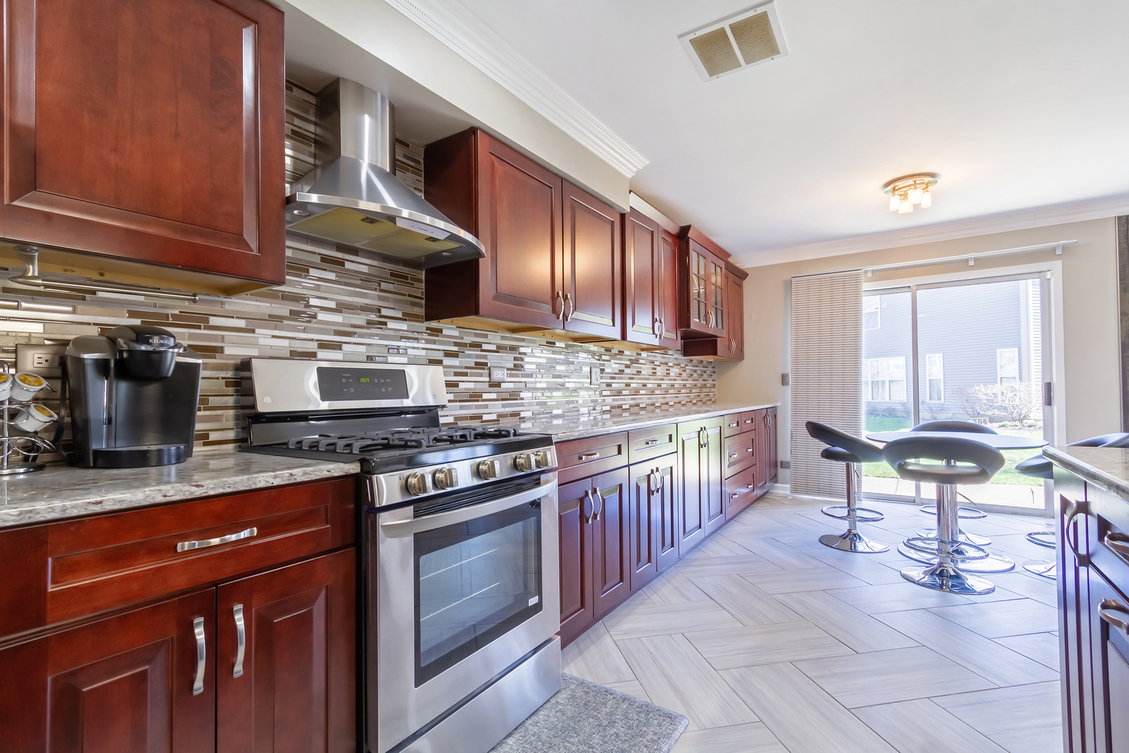 715 Bent Ridge Lane Elgin, IL 60120 - Photo 10 of 20 a kitchen with stainless steel appliances granite countertop a stove a sink and a microwave