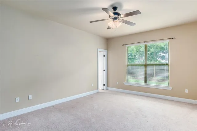 an empty room with a empty space and a ceiling fan