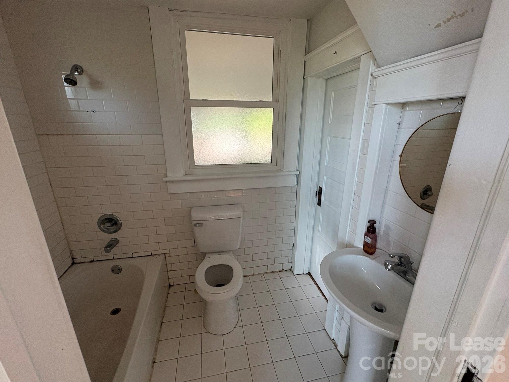 303 Bouchelle Street Morganton, NC 28655 - Photo 11 of 12 a bathroom with a sink a mirror and a toilet