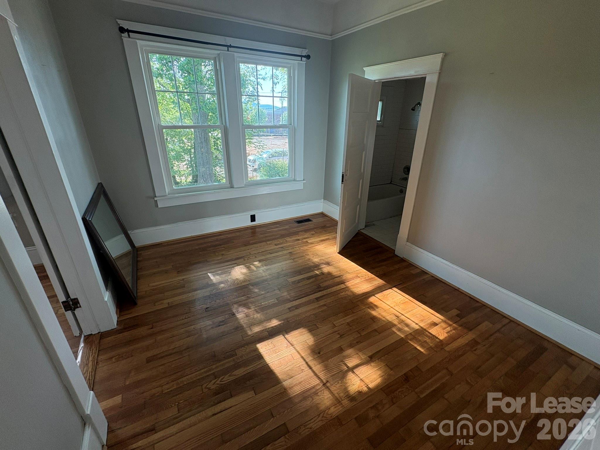 303 Bouchelle Street Morganton, NC 28655 - Photo 6 of 12 a view of an empty room and wooden floor