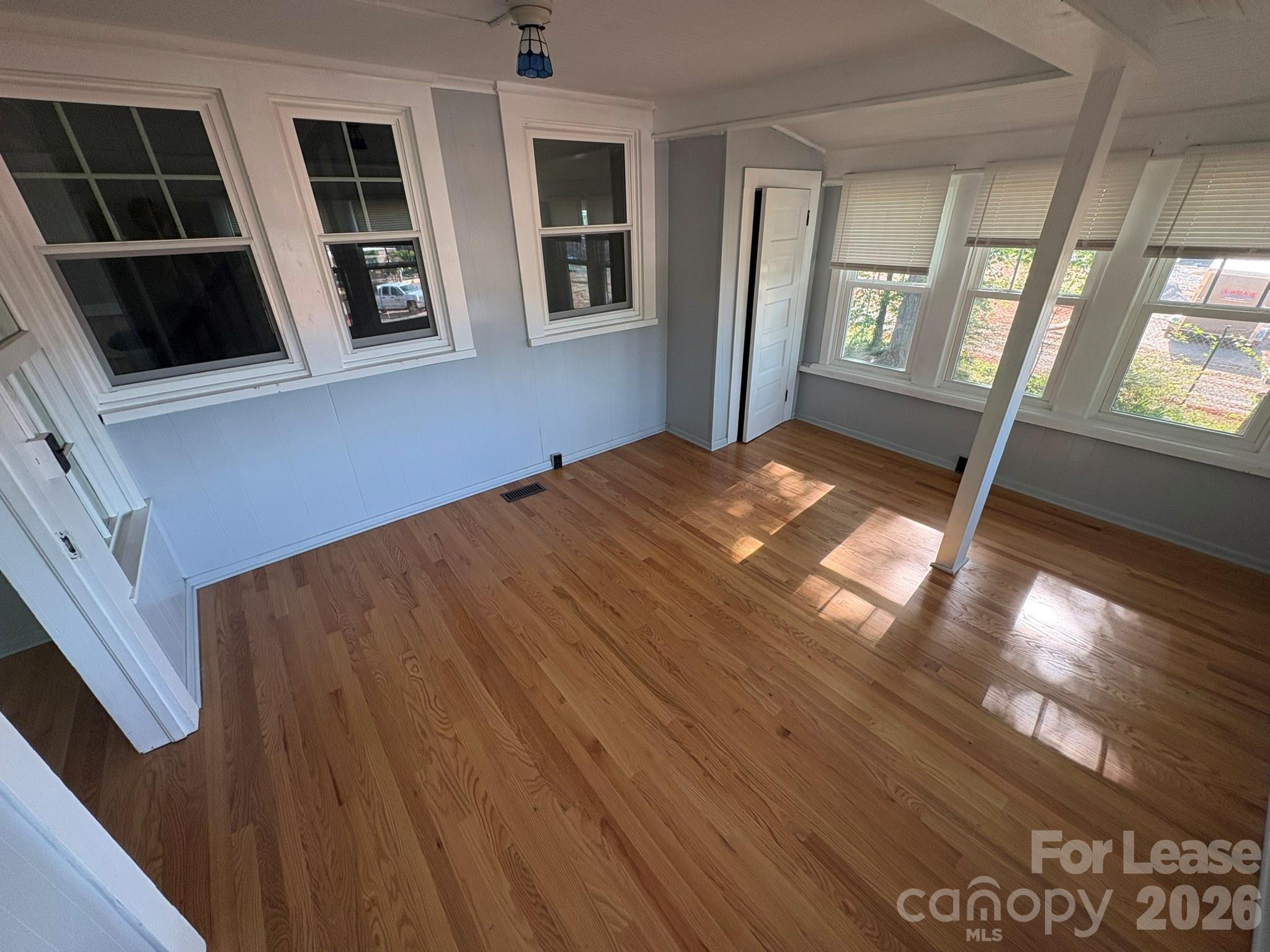 303 Bouchelle Street Morganton, NC 28655 - Photo 7 of 12 a view of an empty room with windows