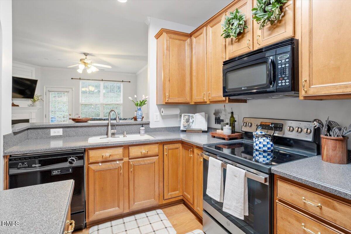 5349 Silver Moon Lane Raleigh, NC 27606 - Photo 11 of 41 a kitchen with stainless steel appliances a sink stove and microwave