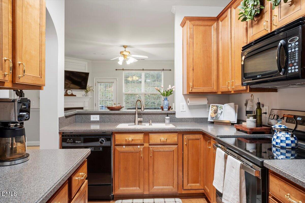 5349 Silver Moon Lane Raleigh, NC 27606 - Photo 13 of 41 a kitchen with a sink stove top oven and cabinets