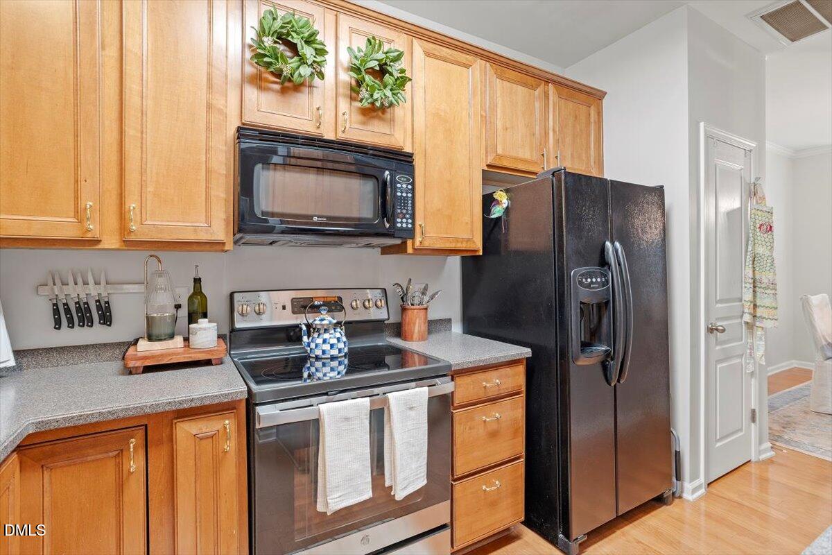 5349 Silver Moon Lane Raleigh, NC 27606 - Photo 15 of 41 a kitchen with stainless steel appliances granite countertop a refrigerator stove and sink