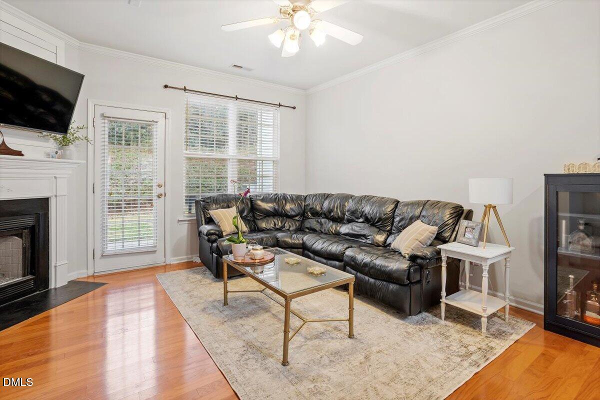 5349 Silver Moon Lane Raleigh, NC 27606 - Photo 17 of 41 a living room with furniture a flat screen tv and a fireplace