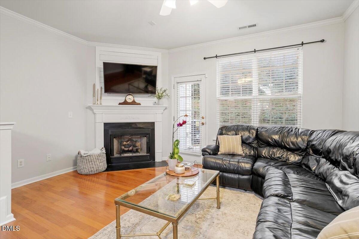 5349 Silver Moon Lane Raleigh, NC 27606 - Photo 18 of 41 a living room with furniture a flat screen tv and a fireplace