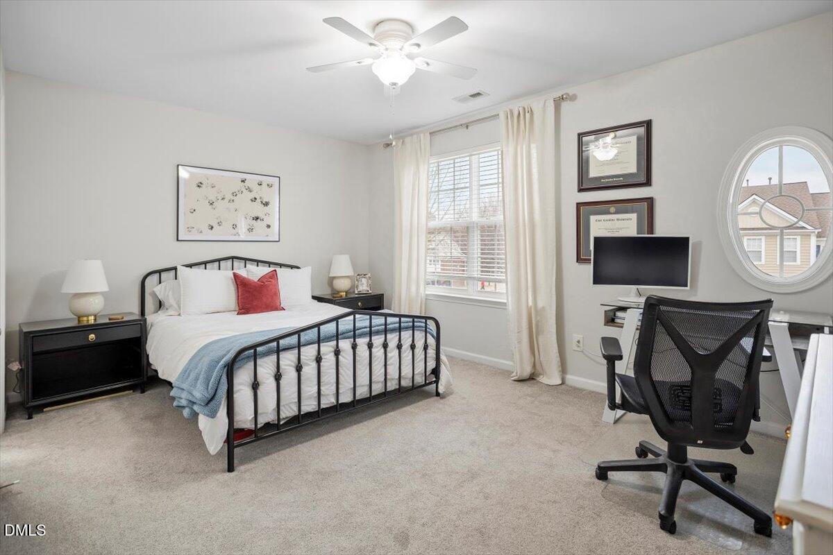 5349 Silver Moon Lane Raleigh, NC 27606 - Photo 21 of 41 a bedroom with a bed a chair and painting on the wall