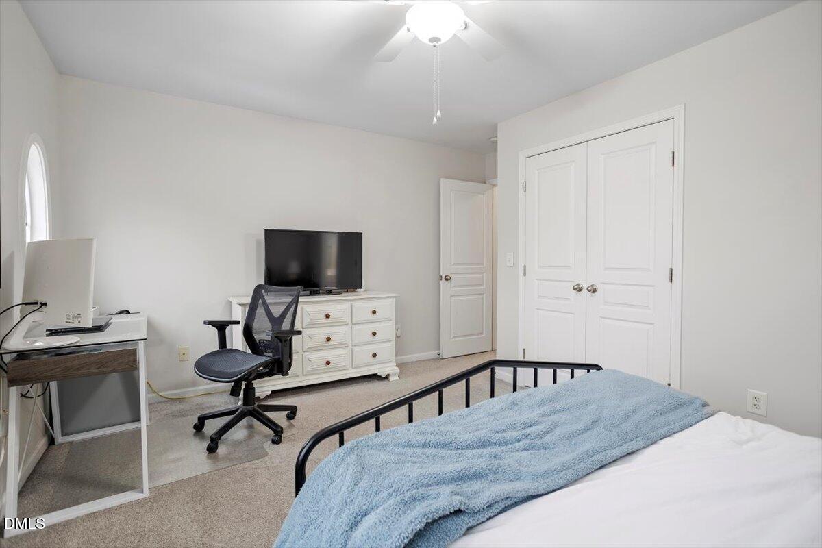 5349 Silver Moon Lane Raleigh, NC 27606 - Photo 23 of 41 a living room with furniture and a flat screen tv