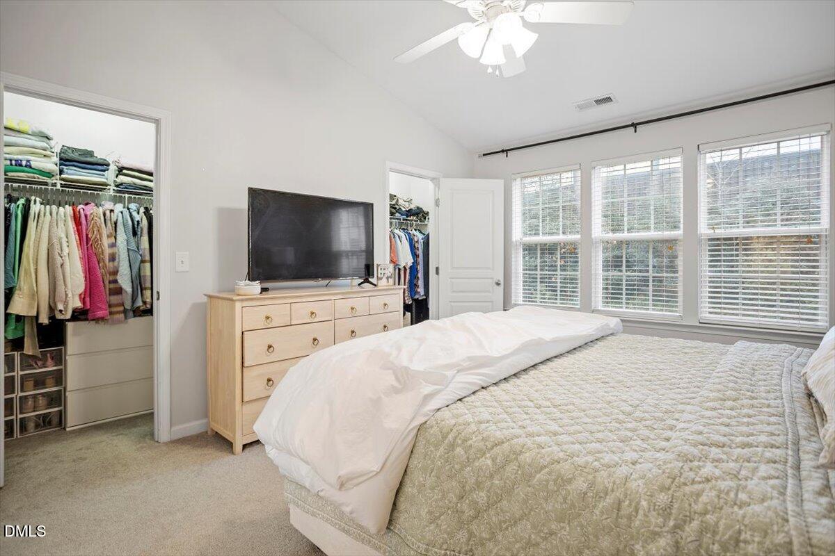 5349 Silver Moon Lane Raleigh, NC 27606 - Photo 27 of 41 a bedroom with a bed and a flat tv screen on dresser